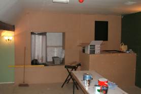 The fireplace begins to take shape at the far end of the bar